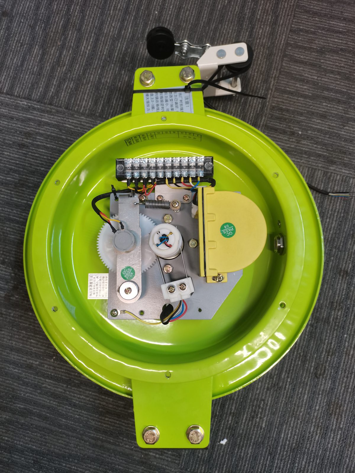 Open draw-wire reel showing the spool and spring