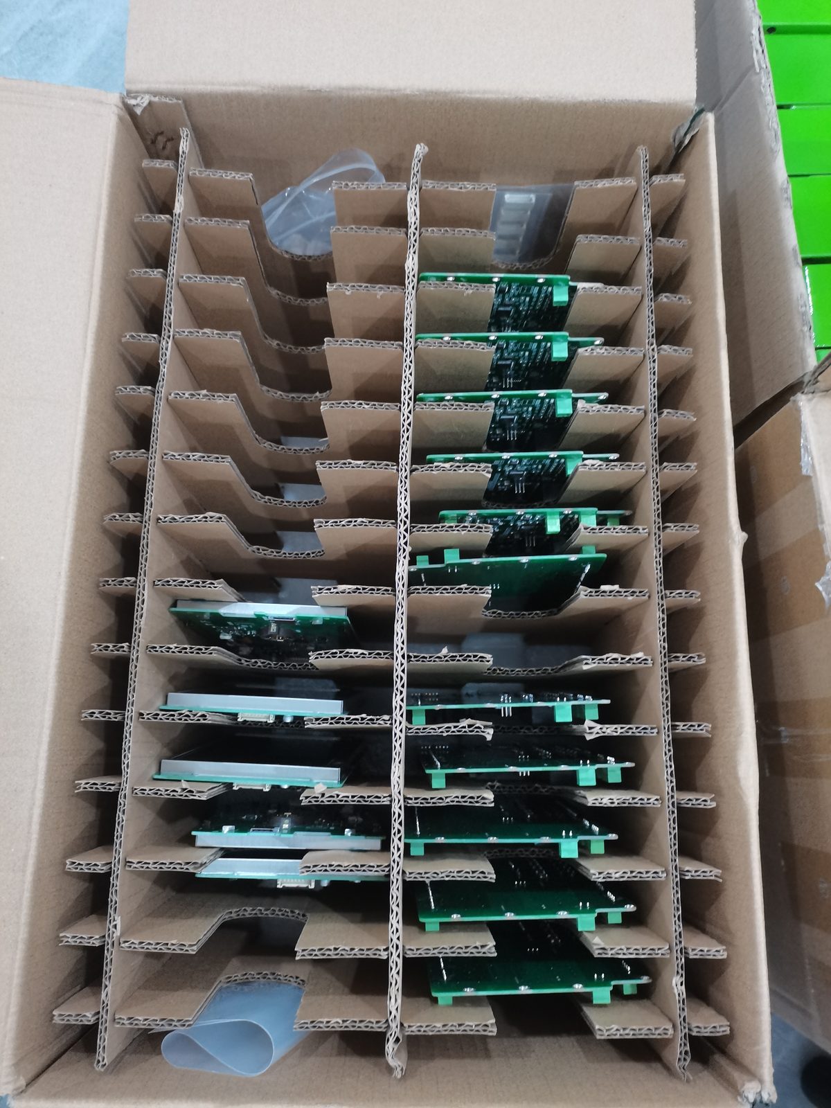 Tray of boards with loomed cable pigtails standing in rows