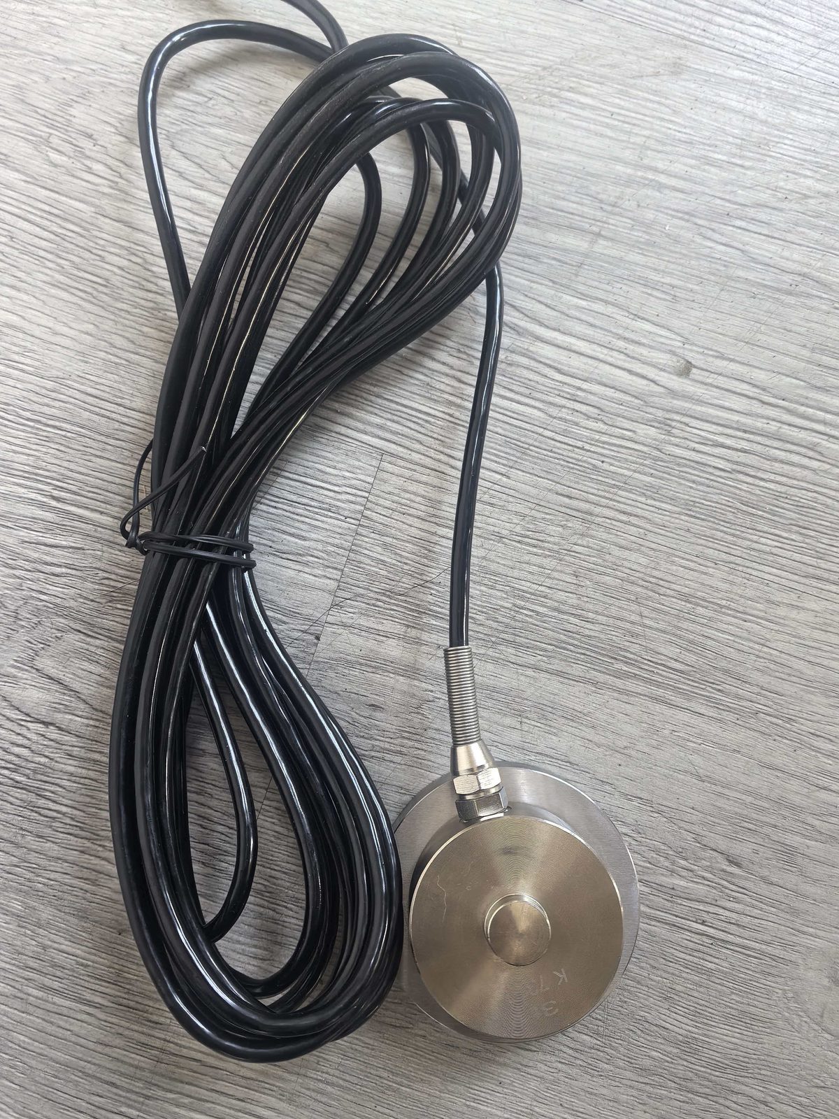 Coiled cable with a spherical float for height and limit sensing