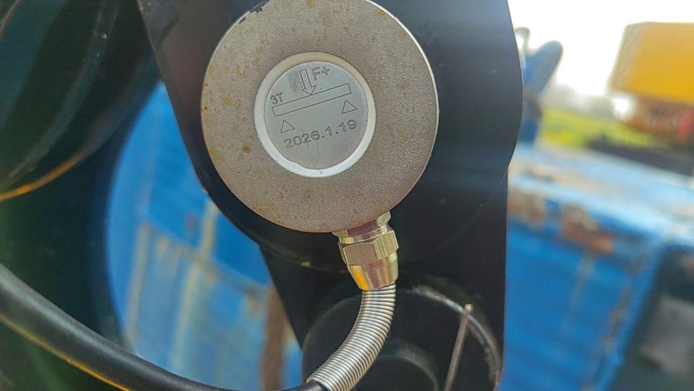 A round pancake cell fixed to a black member with an armoured lead-out and a circular nameplate