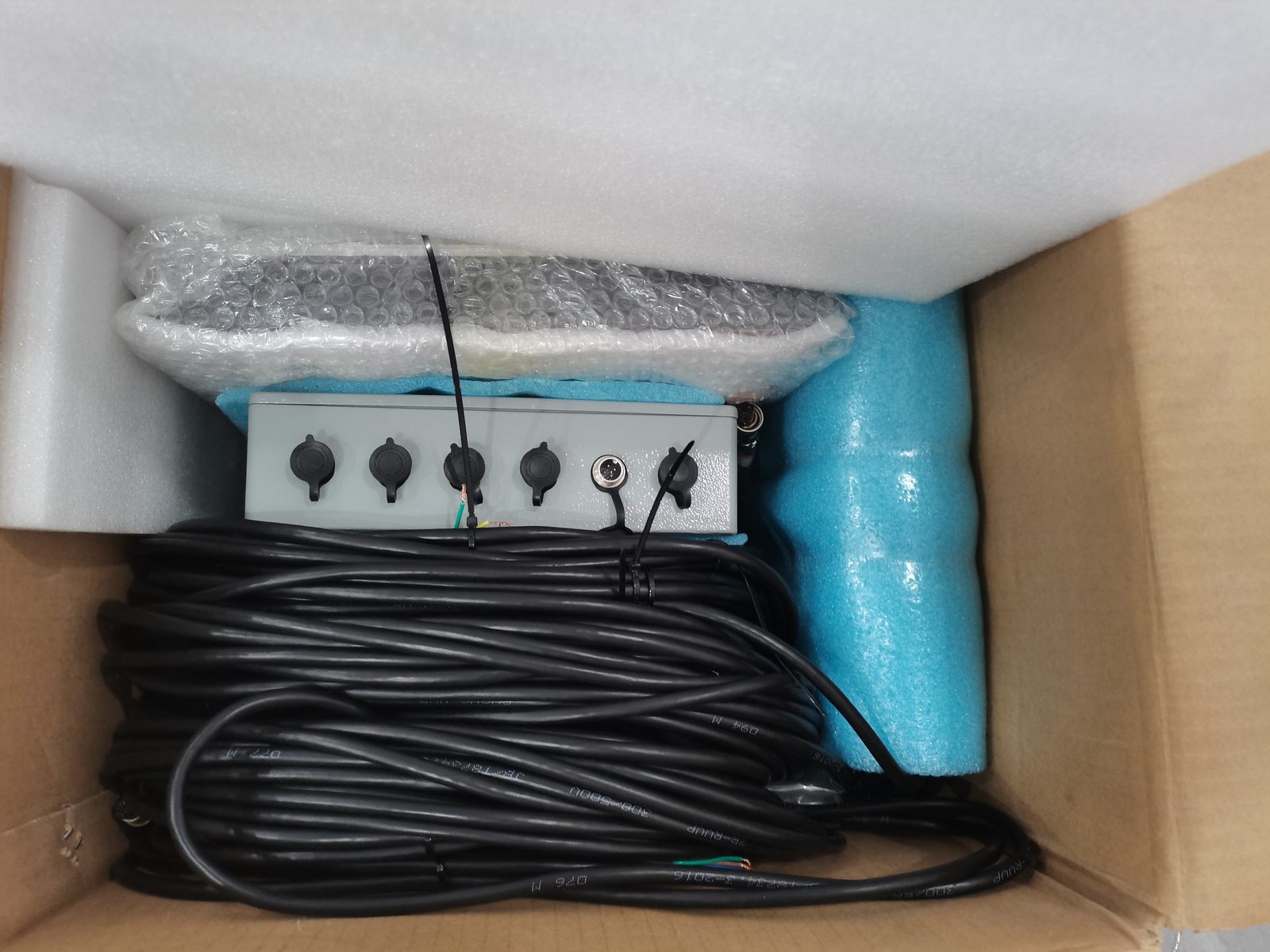 Collector box foam-packed with a long coiled cable run