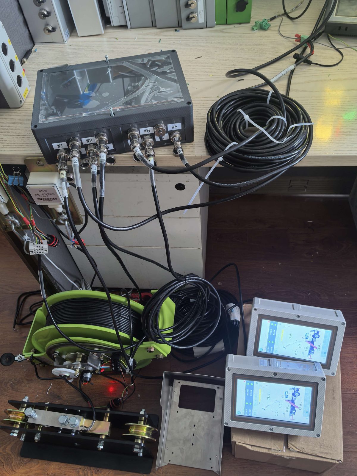Collector, cable reels and two terminals laid out on a desk