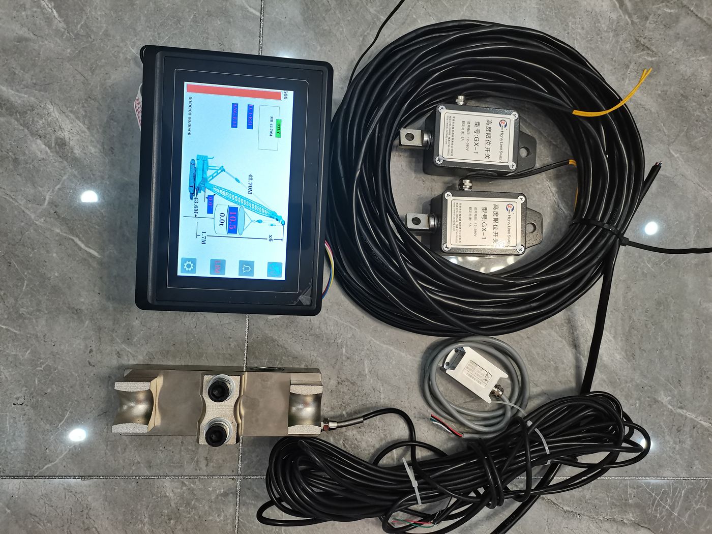 A terminal showing a work page, two labelled pin cells and two cable coils on a tiled floor