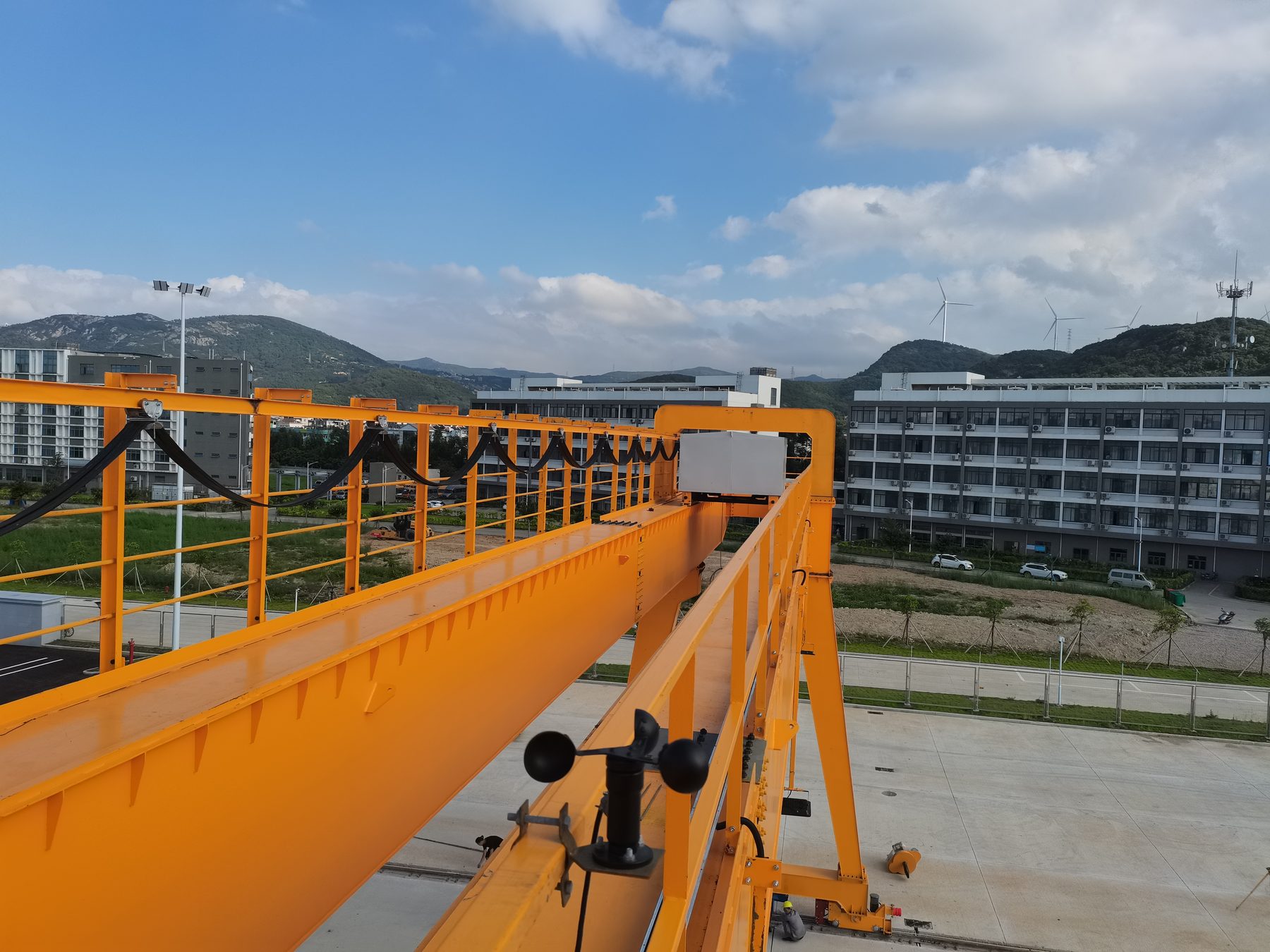 Orange gantry beam with an anemometer mounted on top